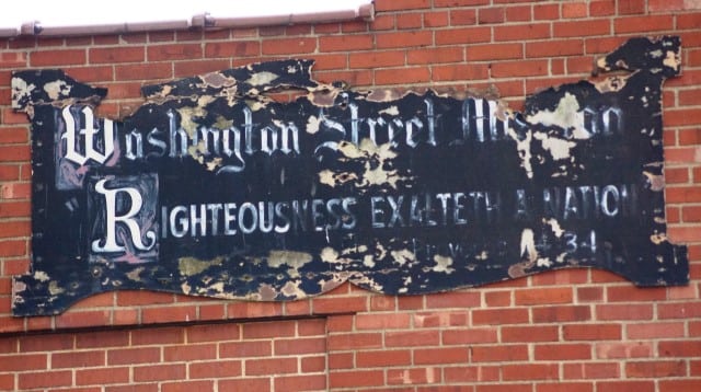 Washington Street Mission's 1910 sign still hangs above the 1920s building on Fourth Street. Washington Street Mission's 1910 sign