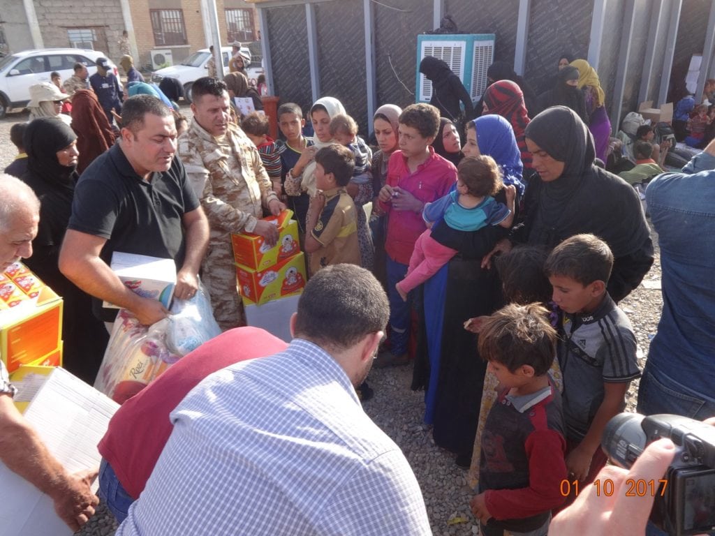 Representatives of the Chaldean Catholic diocese of Kirkuk distribute aid to displaced families earlier this month (October) in Hawija. The center for internally displaced families is 30 miles southwest of the diocesan center where Dominican Friar Yousif Thomas Mirkis is the archbishop. In spite of the challenges Iraq faces Archbishop Mirkis is hopeful about Iraq’s future. (Photo credit: Msgr. Yousif Thomas Mirkis, OP, Chaldean Archbishopric of Kirkuk, Iraq.)