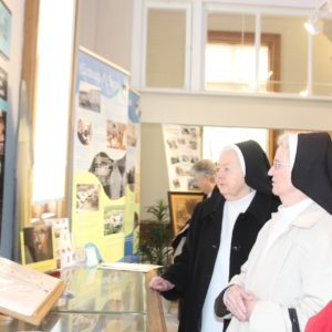 Dominican sisters look at the photos included in the exhibit.