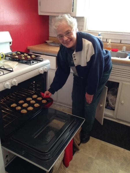 Sister Georgiana pulling cookies out of the oven