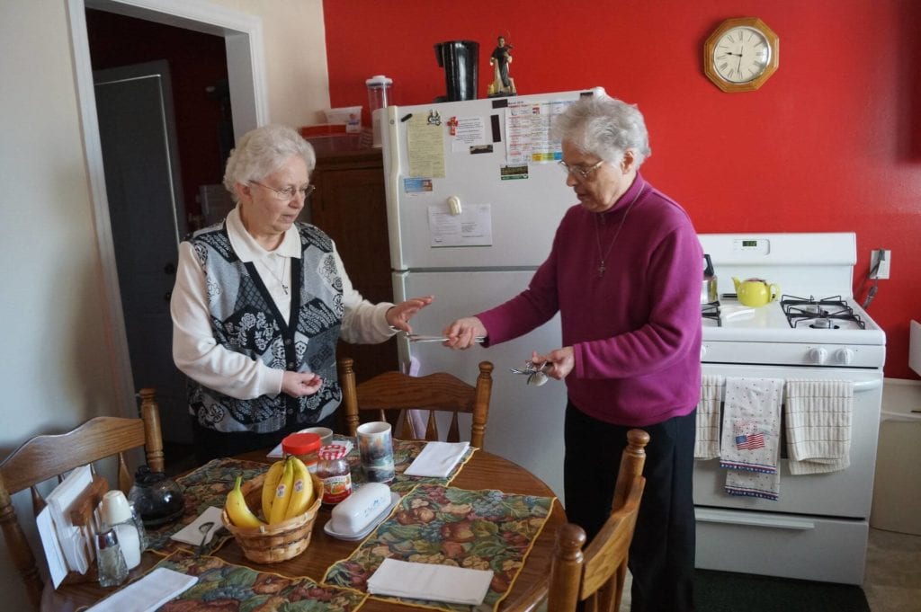 Sister Rose Miriam and Sister Linda Hylla, a sister of the congregation of Divine Providence, cook together in Sister Linda’s kitchen.