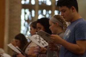 high school students attending mass in chapel