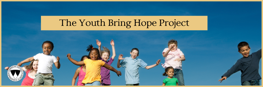 children running and jumping on a grassy hill against a blue sky with the words "The Youth Bring Hope Project" above them