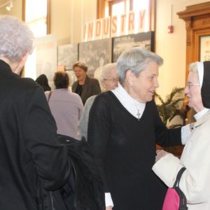 Dominican Sisters visit with Dominican Associates during the grand opening of a new exhibit featuring the history of the Dominican Sisters at the Jacksonville Area Museum.