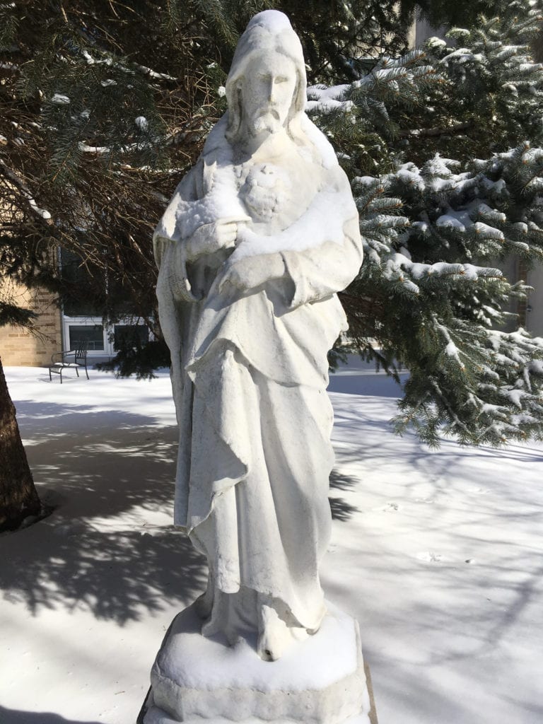 statue of Jesus covered in snow