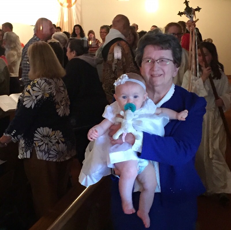 Sister Phyllis Schenk holding a baby