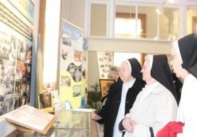 Dominican sisters look at the photos included in the exhibit.