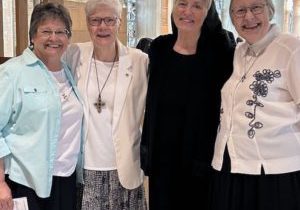 Members of the Dominican Sisters of Springfield leadership team stand arm in arm in the beautiful chapel light. From left: Sisters Elyse Marie Ramirez, Joanne Delehanty, M. Paul McCaughey, and Kathlyn Mulcahy.