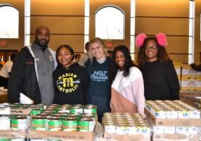 From left are Marian Catholic Campus Minister Curtis Johnson, Lauren Richardson, Haley Trojan, Kylie Kimbrough and Kimbrough’s mother, Tameka Berry, gather to assemble and distribute food boxes before the Thanksgiving holiday.