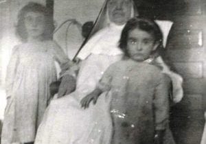 Undated photo. Sister Rachel Conway with two children, Sacred Heart Convent, Springfield, Ill.